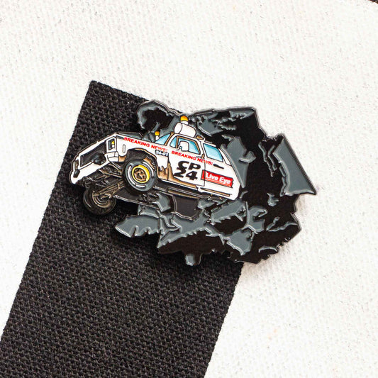 An enamel pin of the CP24 truck smashing through the wall of the CHUM-City building.