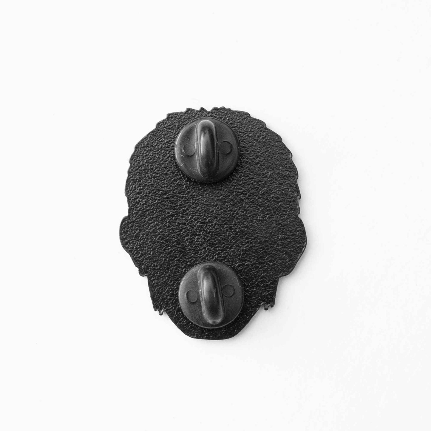 The back of a soft enamel pin with two rubber stoppers.