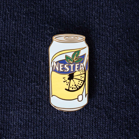 A hard enamel pin of a Nestea soda can.