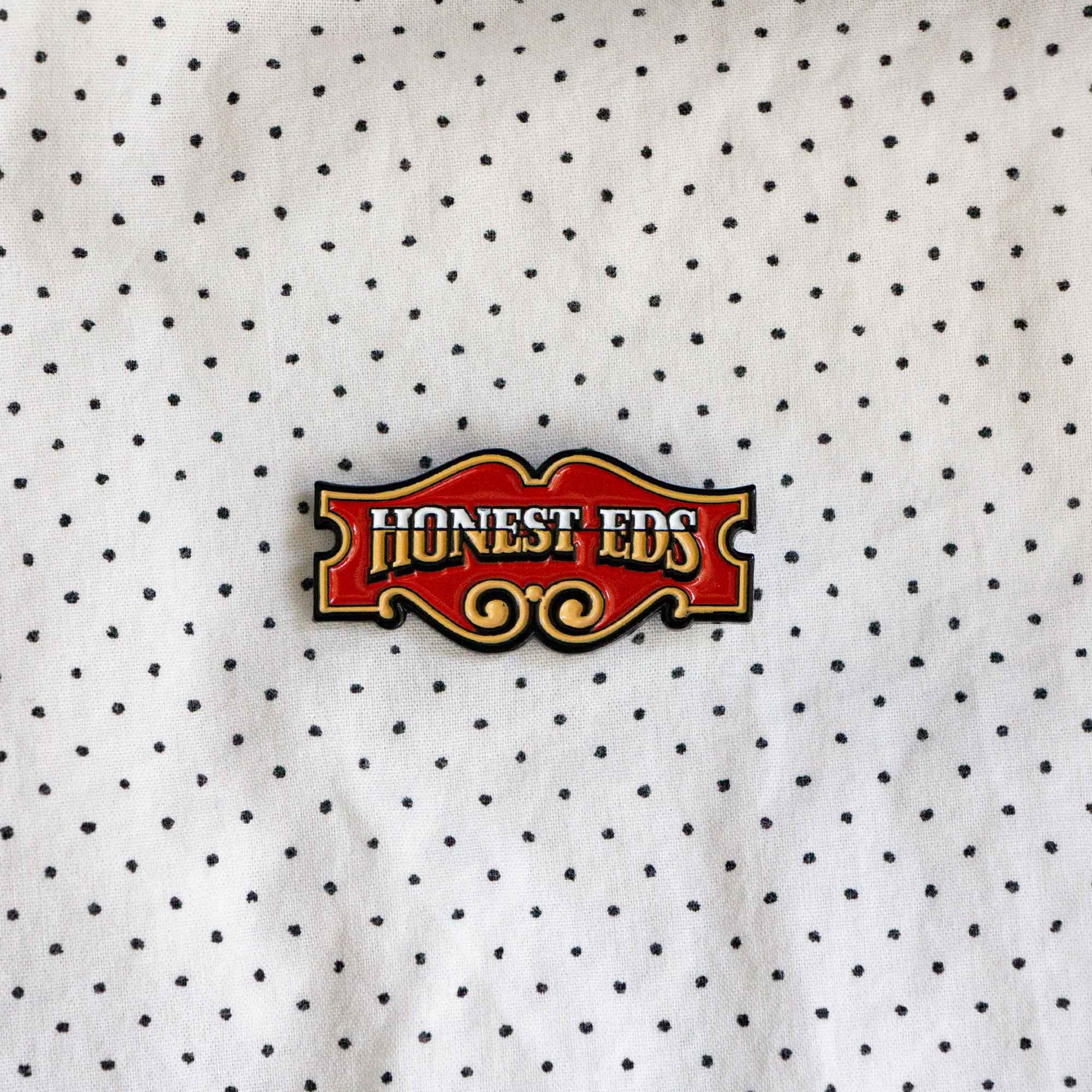 An enamel pin of the iconic Honest Ed's store sign, a landmark discount store in Toronto, Ontario, Canada.