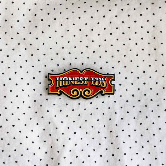 An enamel pin of the iconic Honest Ed's store sign, a landmark discount store in Toronto, Ontario, Canada.