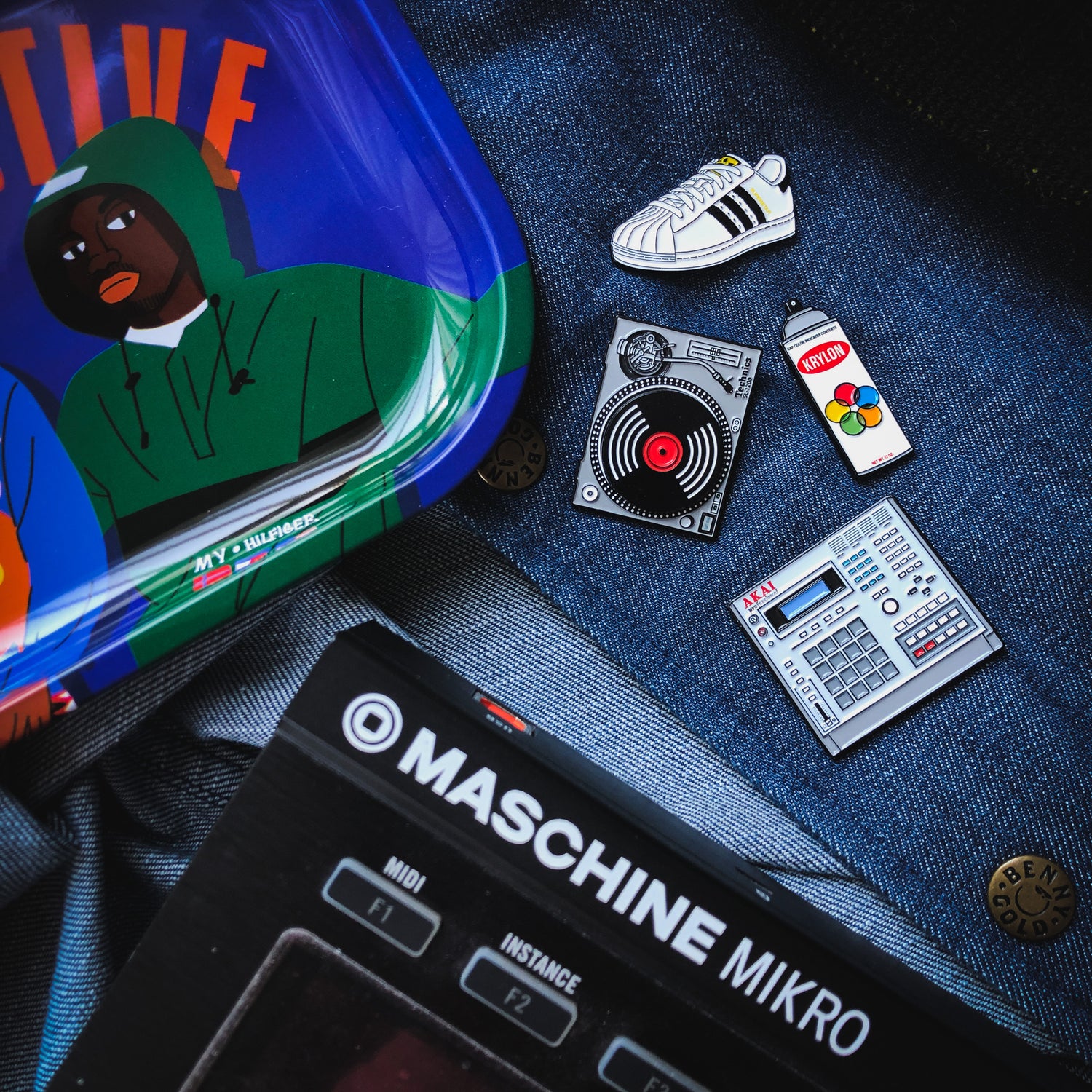 A collection of hip-hop themed enamel pins.
