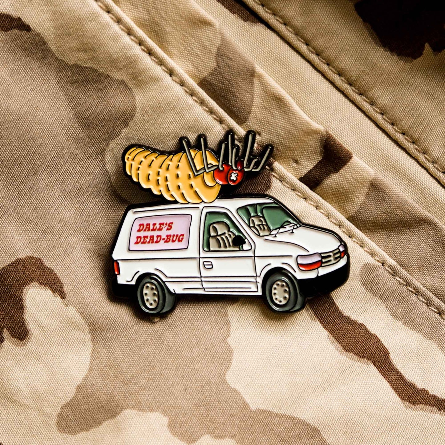 Dale's Dead-Bug truck nicknamed, the "Bug-ebago", from the hit cartoon series, King of the Hill, is pictured in this photo as a soft enamel pin design.