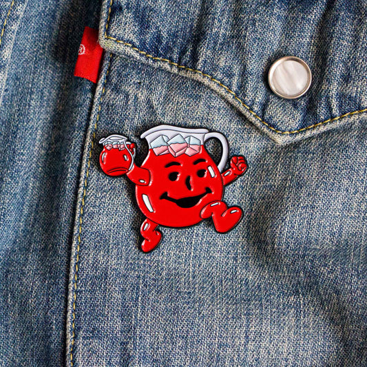 A soft enamel pin of the Kool-Aid Man.