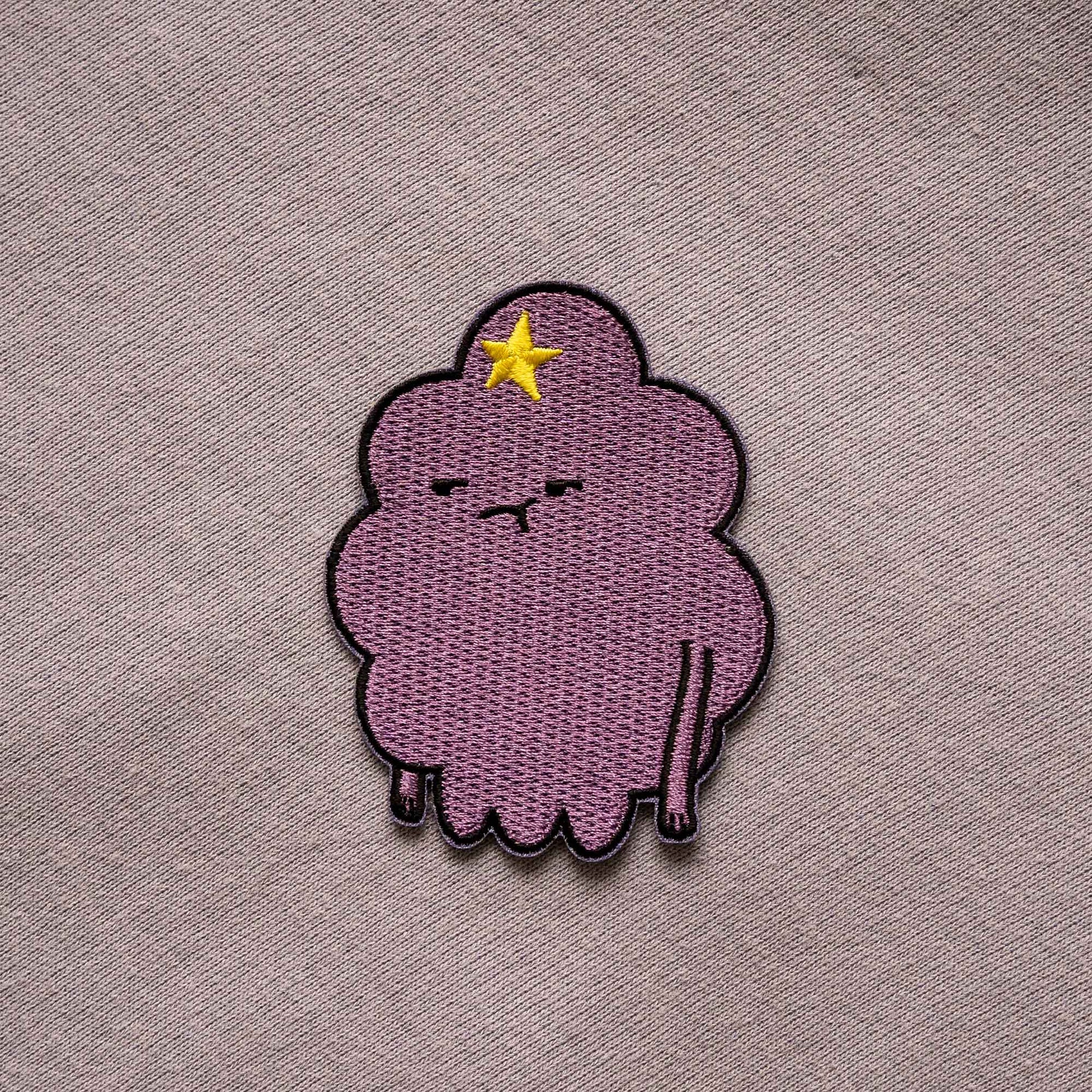 An iron-on patch of Lumpy Space Princess, from the animated series Adventure Time.