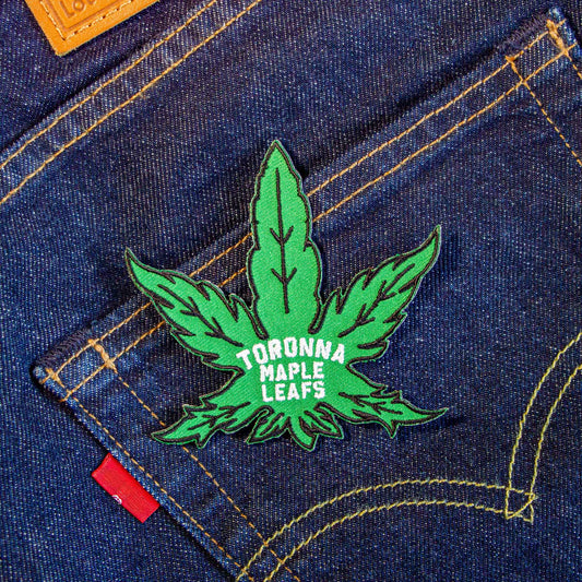 An iron-on patch that's a parody of the Toronto Maple Leafs as a marijuana leaf.